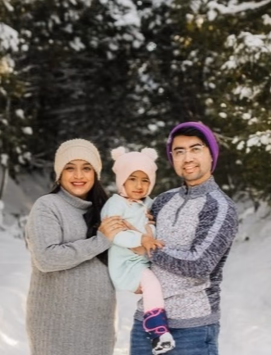 Dr. Nadia Shaikh with her family, outdoors in winter.